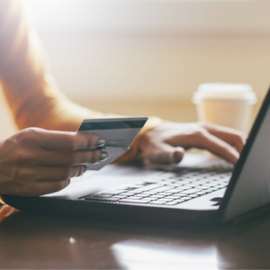 person ordering on computer with credit card